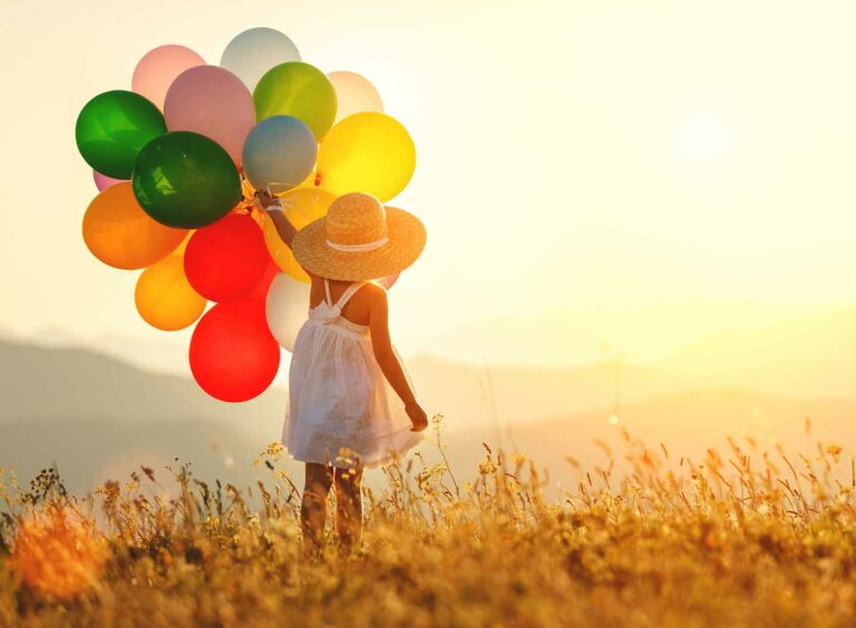 young girl with straw hat in field holding balloons | Lake Zurich IL