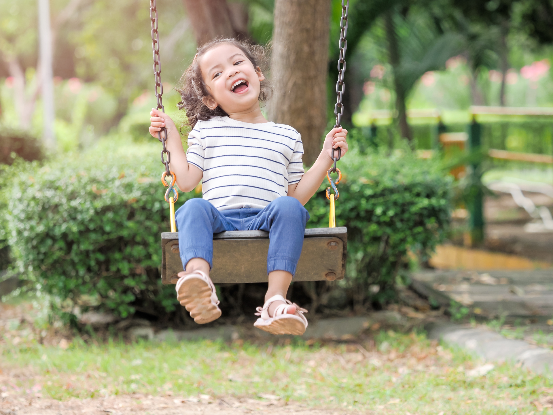 smiling child on swing