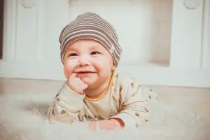 smiling baby on floor smiling